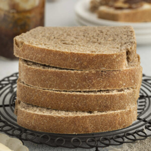 Four slices of sprouted wheat bread stacked on top of each other.