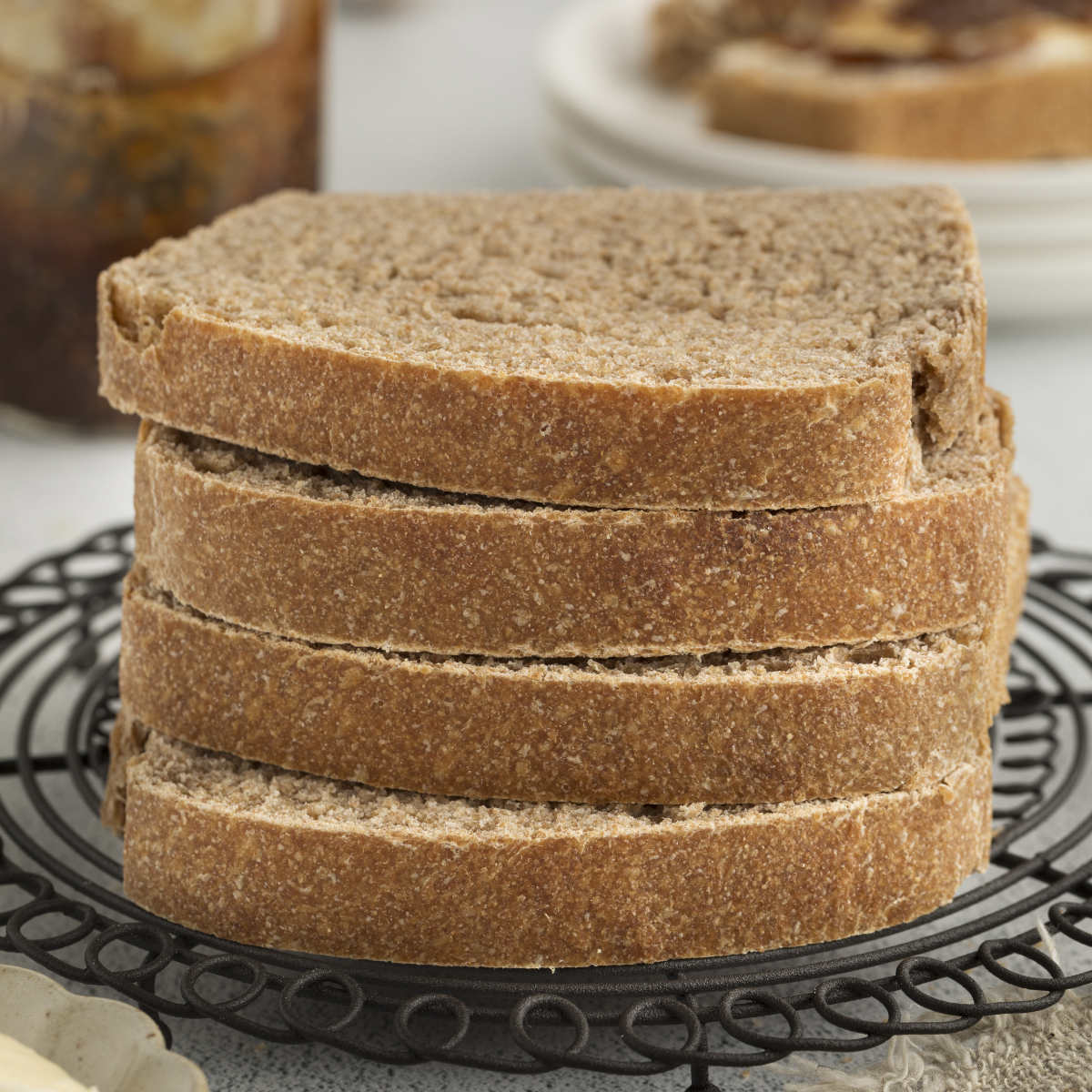 Four slices of sprouted wheat bread stacked on top of each other.