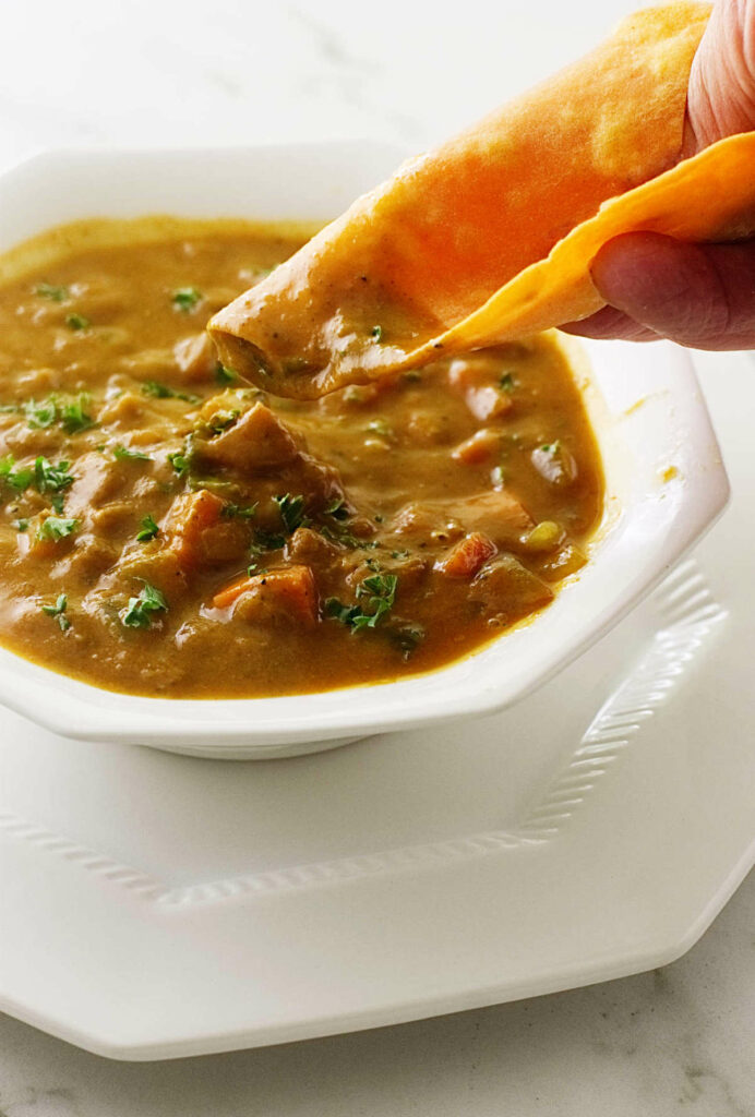 Dipping a sweet potato flatbread into lentil soup. 