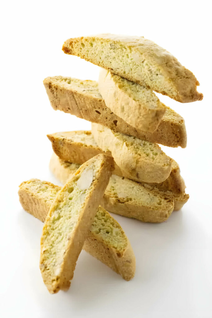 A stack of almond biscotti cookies on a white counter.