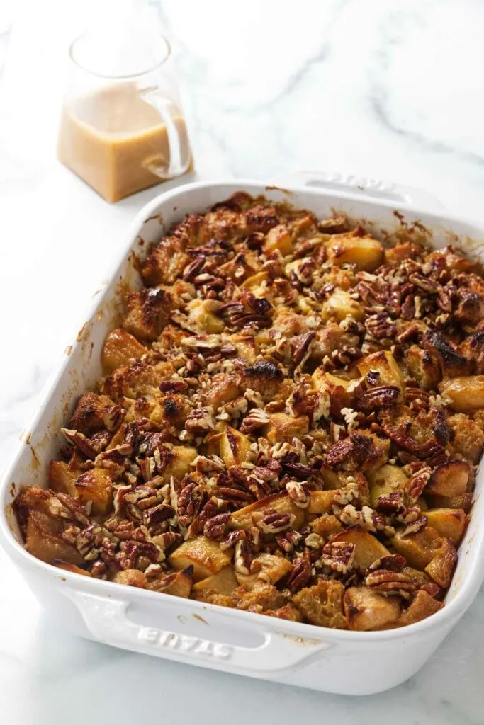 A baking dish of apple bread pudding fresh out of the oven.