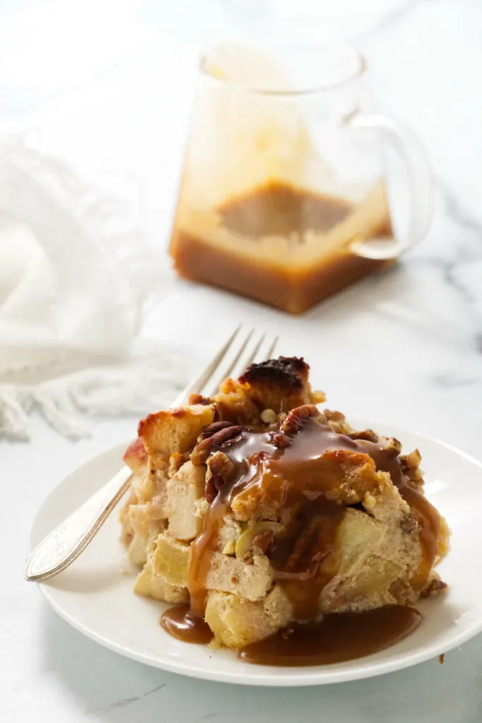 A slice of maple apple bread pudding with pecans.