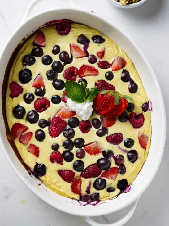 A baking dish with baked yogurt and eggs with berries.