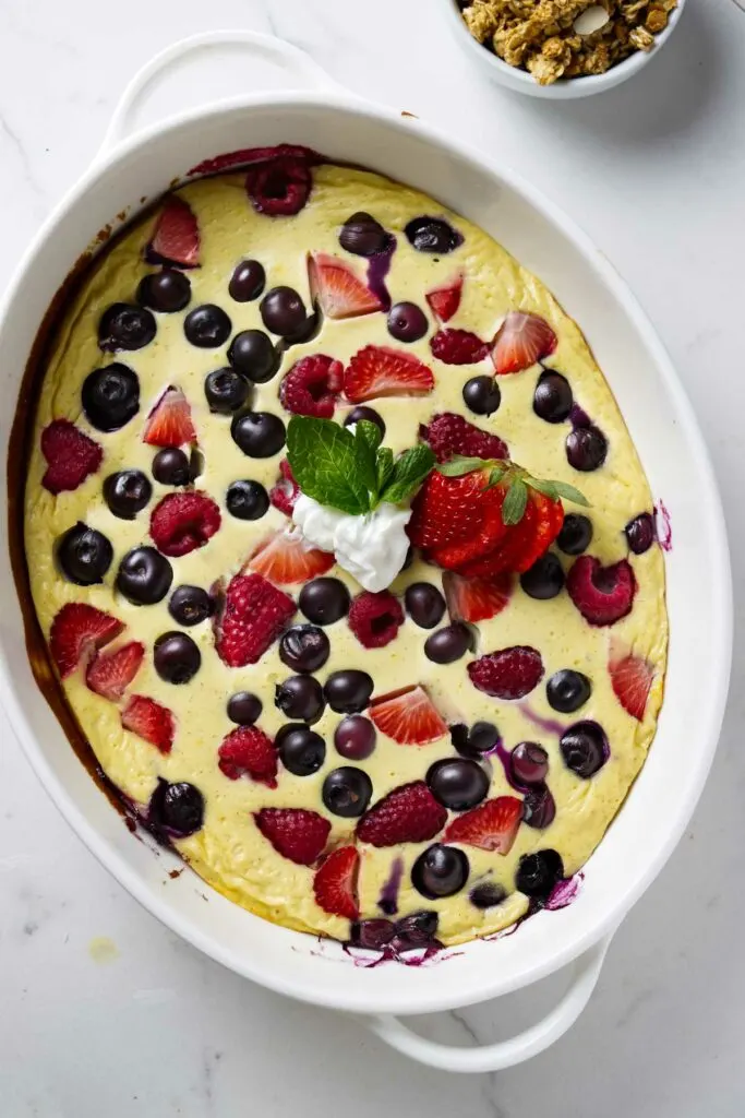 A baking dish with baked yogurt and eggs with berries.