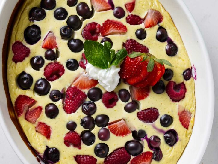 A baking dish with baked yogurt and eggs with berries.