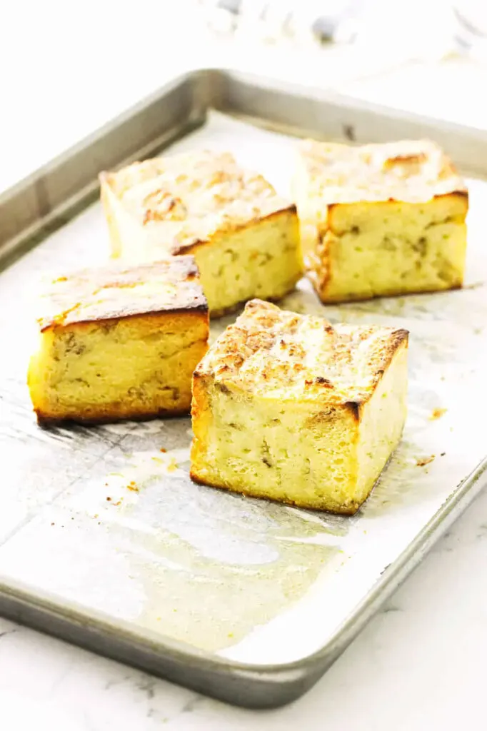 Crisping up the edges of slices of bread pudding.