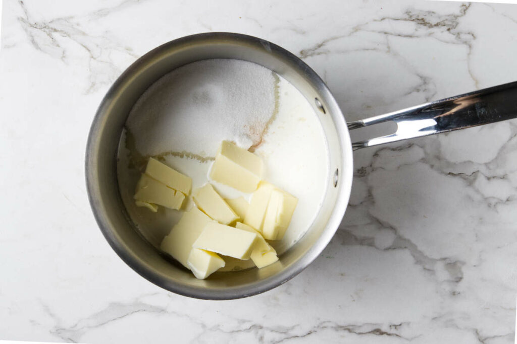 Melting cream, butter and sugar in a saucepan.