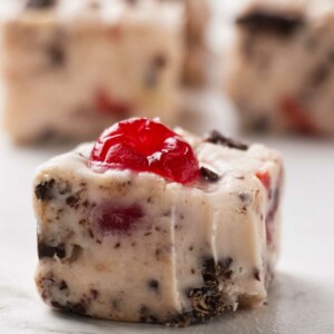 A square of cherry garcia fudge with several more slices in the background.