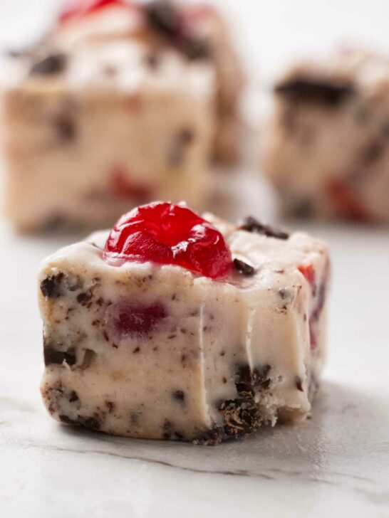 A square of cherry garcia fudge with several more slices in the background.