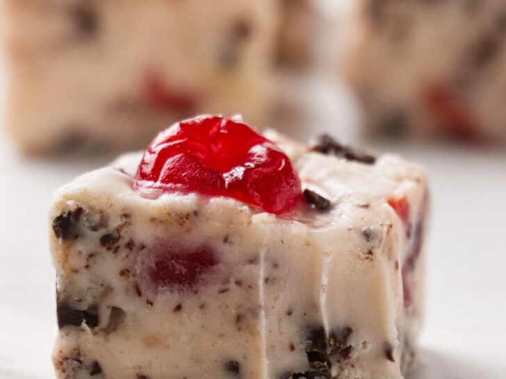 A square of cherry garcia fudge with several more slices in the background.