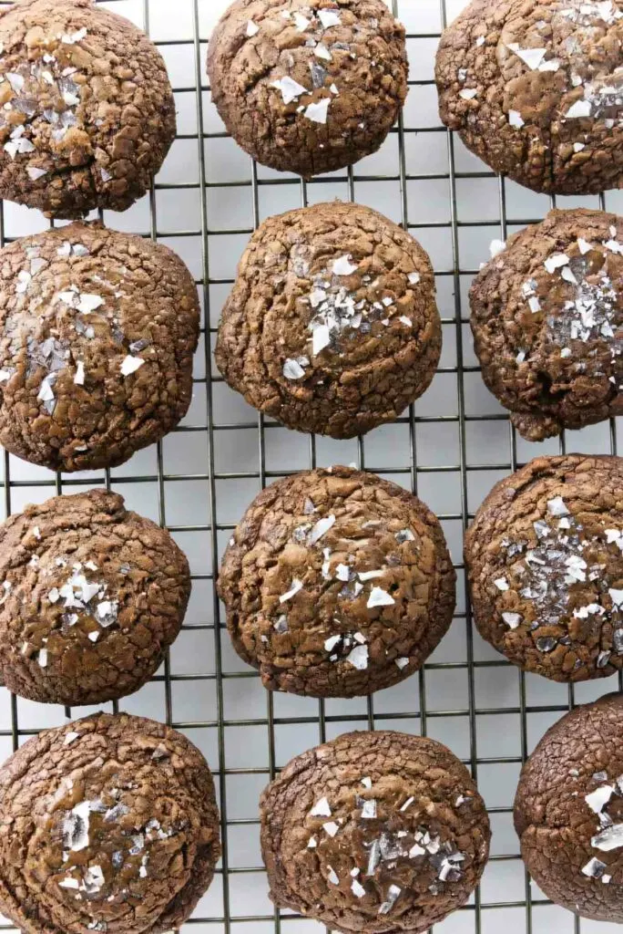 Several chocolate cookies on a cooling rack.