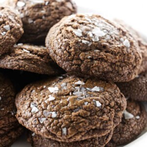 A stack of salted chocolate truffle cookies on a platter.