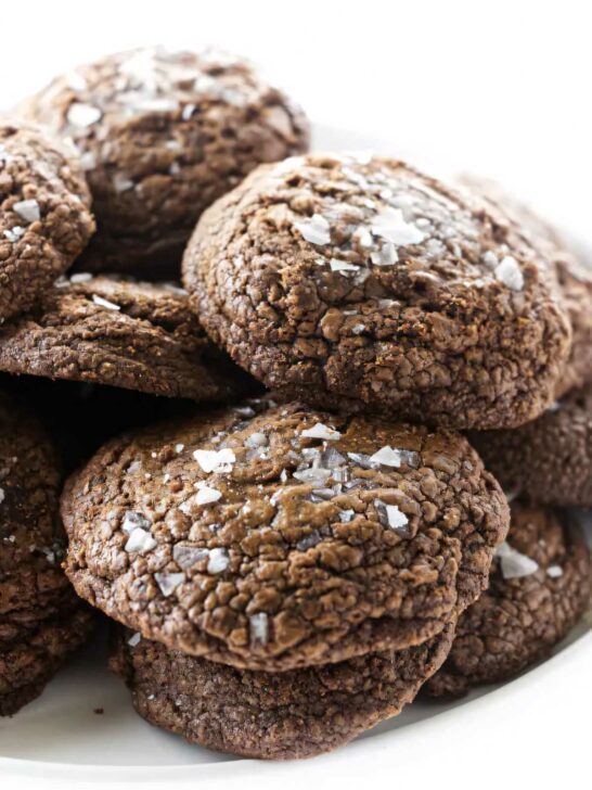 A stack of salted chocolate truffle cookies on a platter.