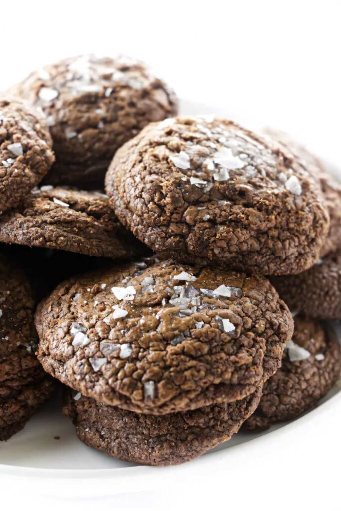 A stack of salted chocolate truffle cookies on a platter.