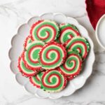 A plate of red and green swirled pinwheel cookies.