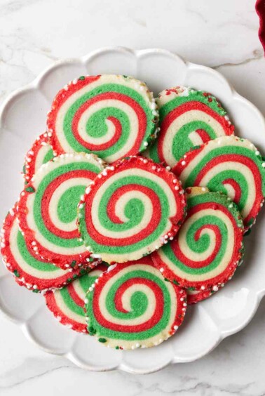 A plate of red and green swirled pinwheel cookies.