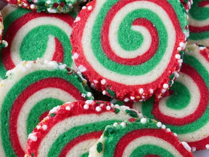 A plate of red and green swirled pinwheel cookies.