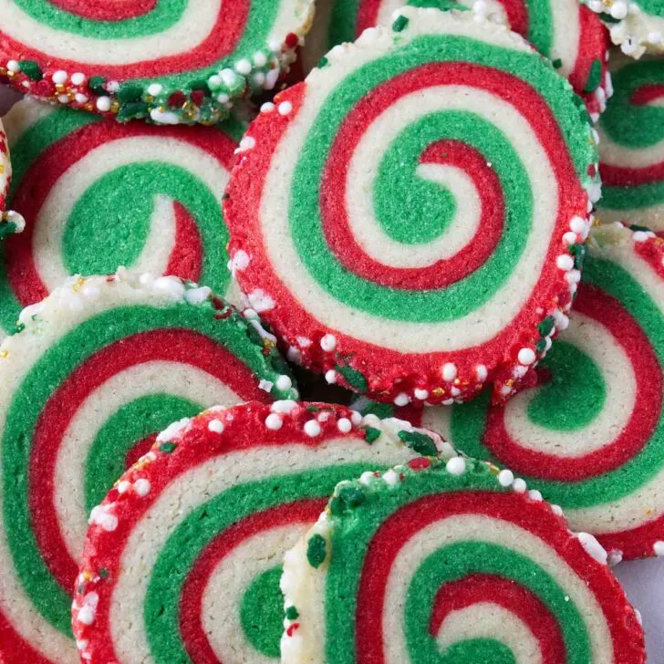 A plate of red and green swirled pinwheel cookies.