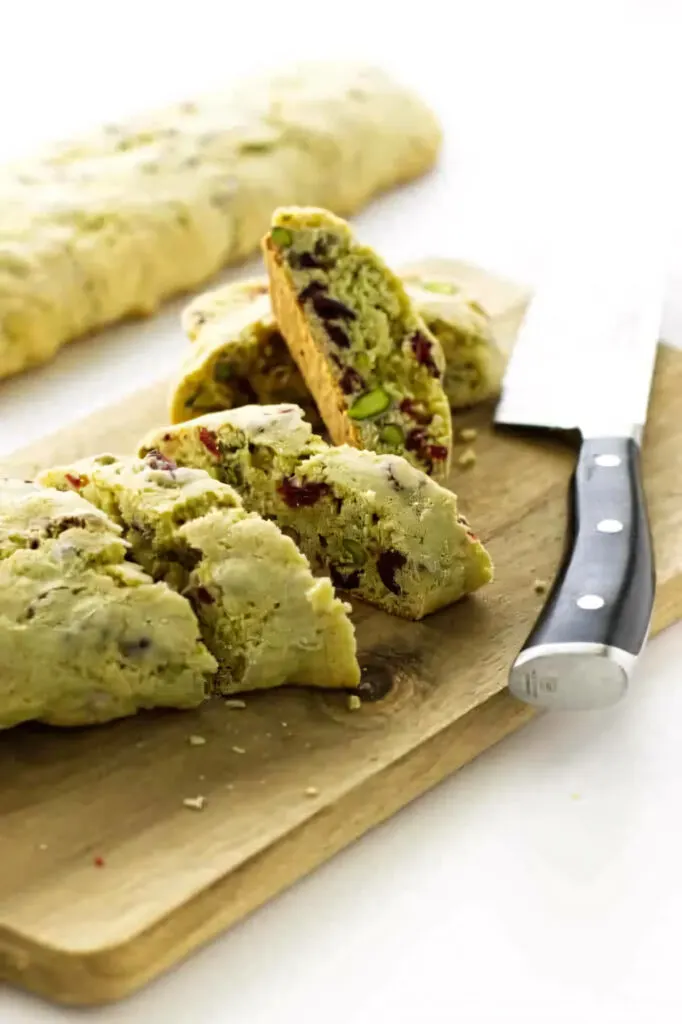 slicing biscotti into individual cookies to be baked again.