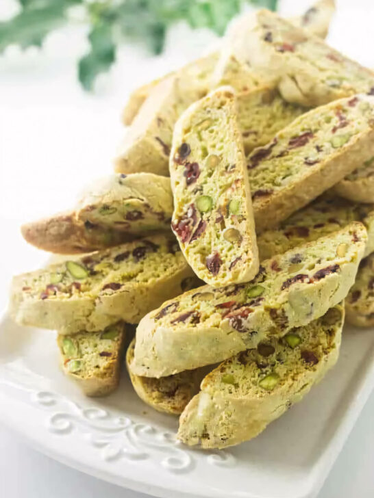 Several pistachio cranberry biscotti on a serving platter.