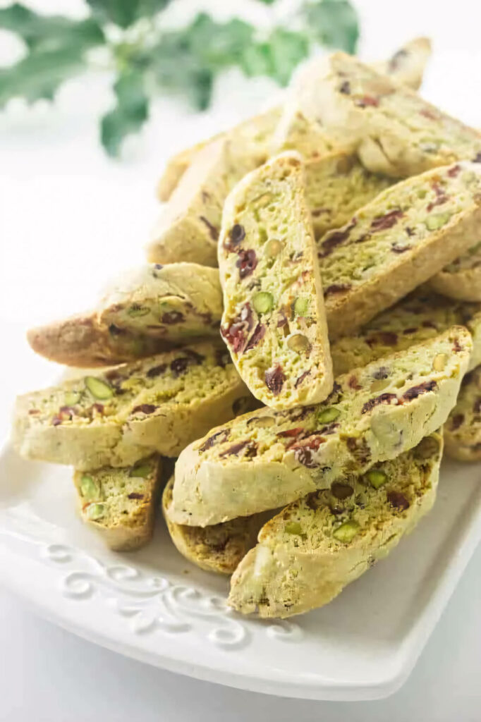 Several pistachio cranberry biscotti on a serving platter.