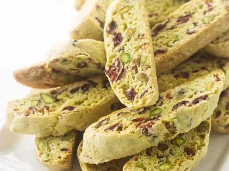 Several pistachio cranberry biscotti on a serving platter.