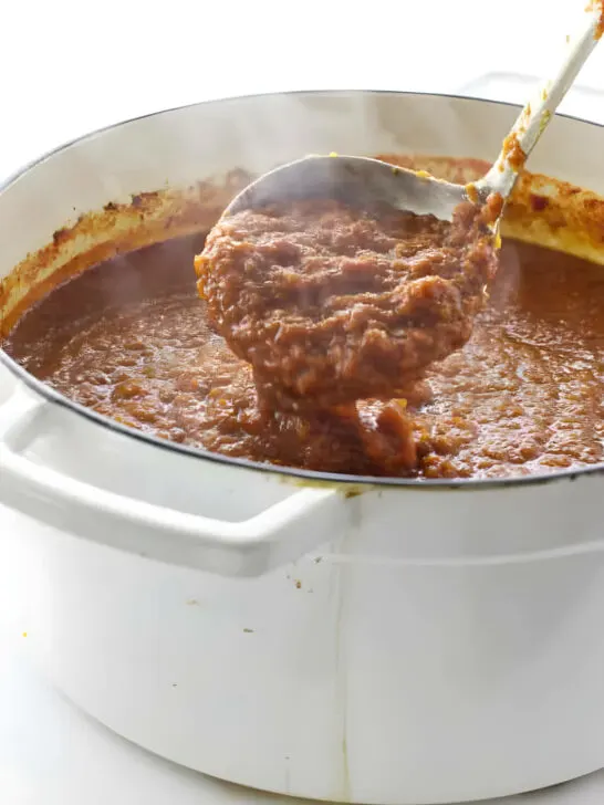 A large pot of pasta sauce made with red wine.