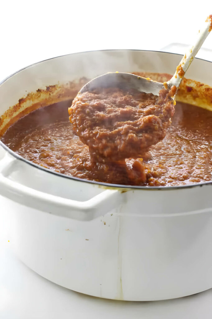 A large pot of pasta sauce made with red wine.