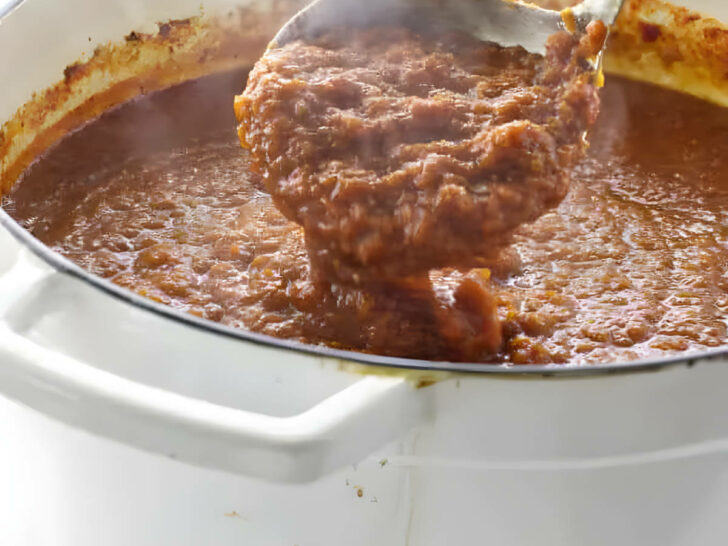 A large pot of pasta sauce made with red wine.