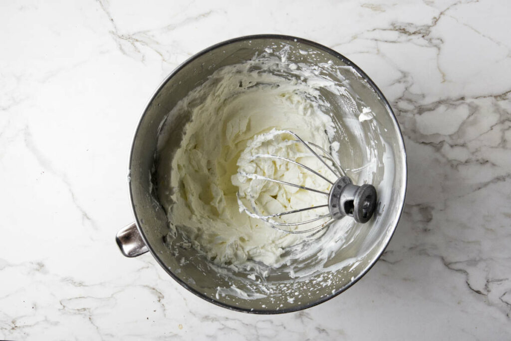 Beating whipped cream for the top of the dessert lasagna.