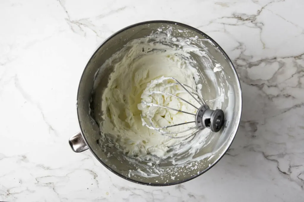 Beating whipped cream for the top of the dessert lasagna.