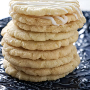 A stack of nine crunchy lemon biscuits stacked on top of each other.