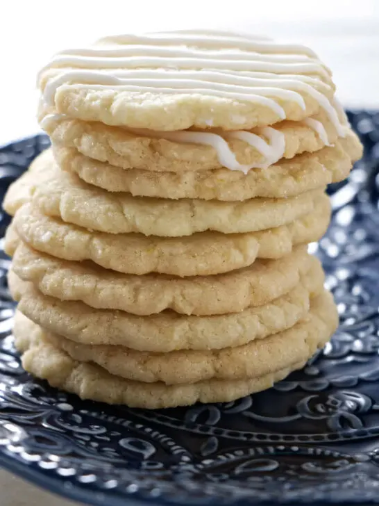 A stack of nine crunchy lemon biscuits stacked on top of each other.