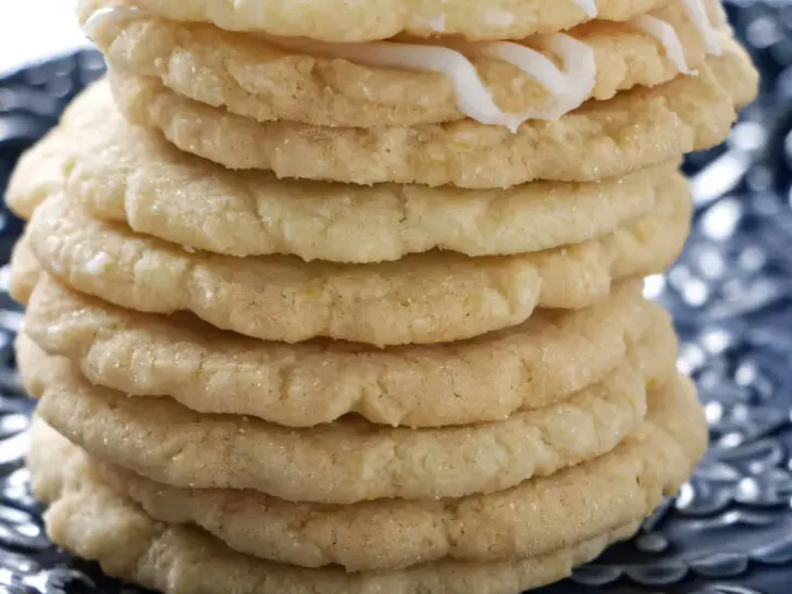 A stack of nine crunchy lemon biscuits stacked on top of each other.