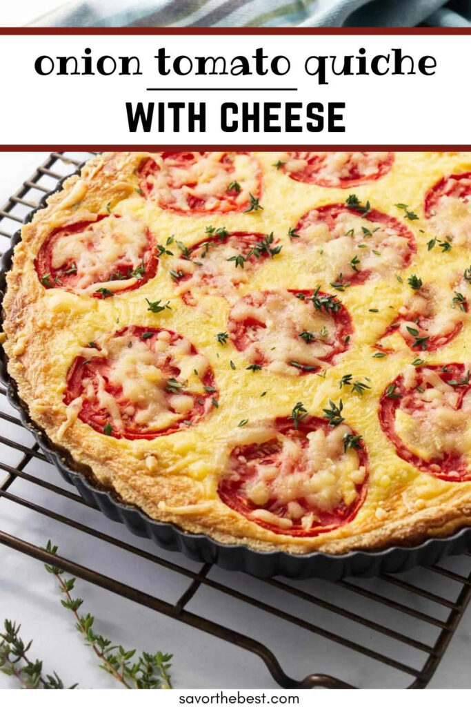 A tomato quiche on a cooling rack next to fresh herbs.