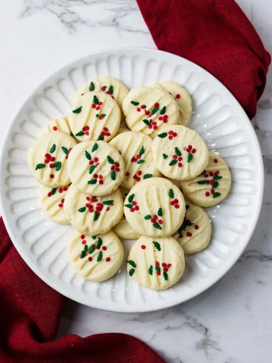 A plate filled with Christmas shortbread cookies.