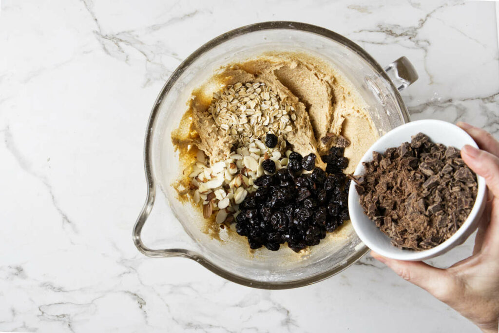 Adding dark chocolate and cherries to biscotti dough made with whole wheat.