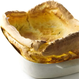 A 13 x 9 inch pan with a large yorkshire pudding puffed up around the edges.