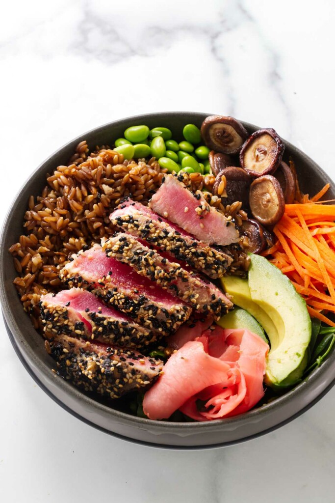 A cooked tuna poke bowl with seared tuna steak.