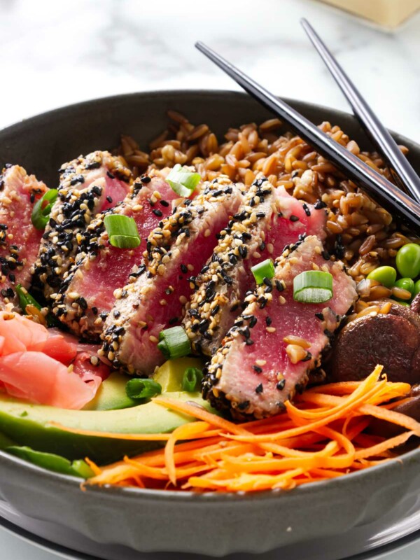 Tuna steak poke bowl with chopsticks next to the bowl.