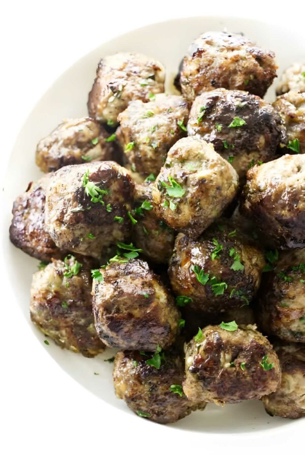 A bowl of stovetop meatballs with parsley garnish.