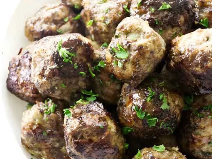 A bowl of stovetop meatballs with parsley garnish.