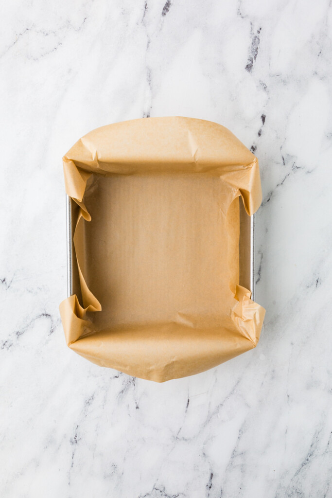 Lining a baking dish with parchment paper before adding egg bake cottage cheese mix.