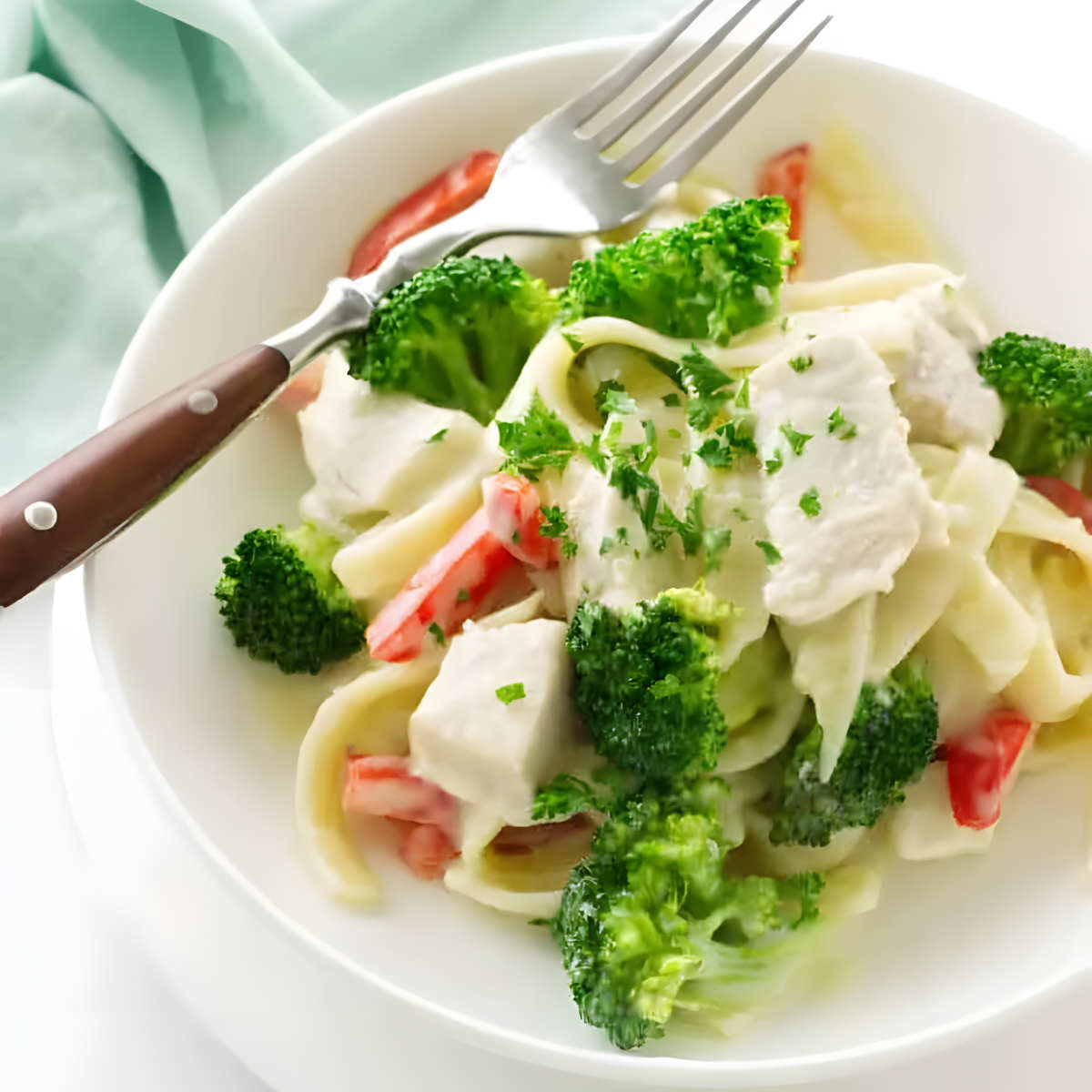 Creamy chicken and broccoli pasta in a bowl.