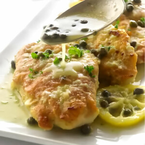 Drizzling sauce over chicken piccata.