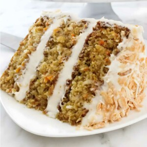 A slice of carrot cake with pineapple and coconut.