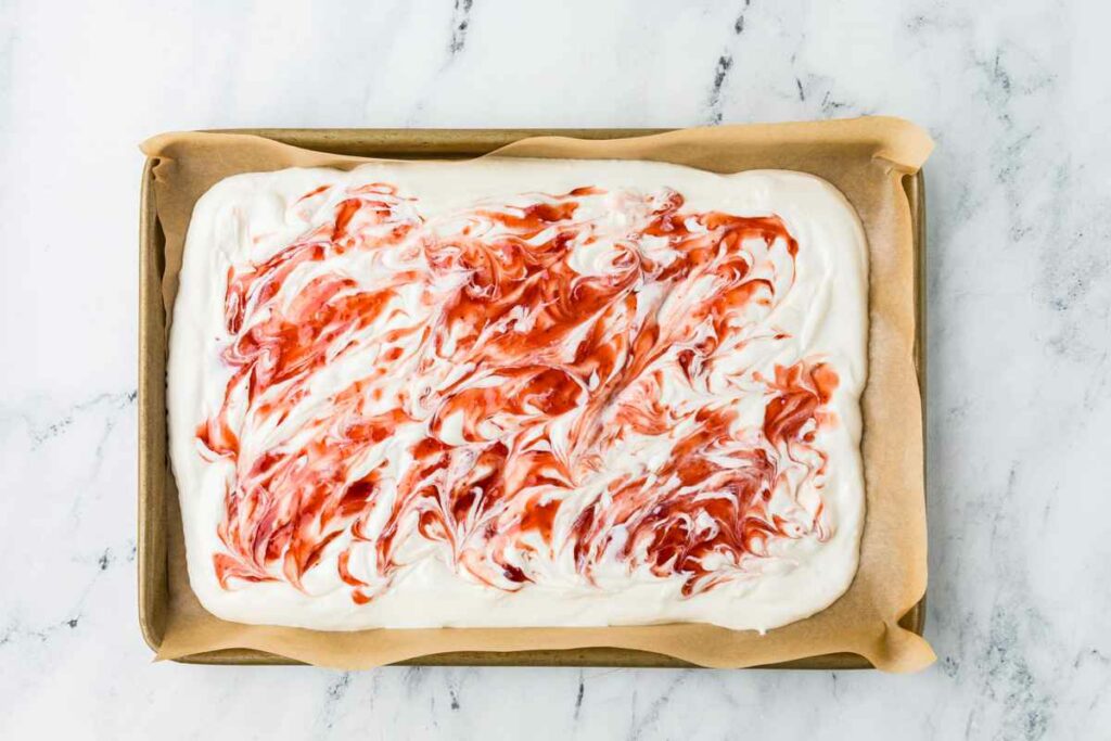 Swirling the jam into the yogurt.