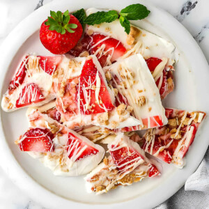 A plate filled with strawberry frozen yogurt bark.