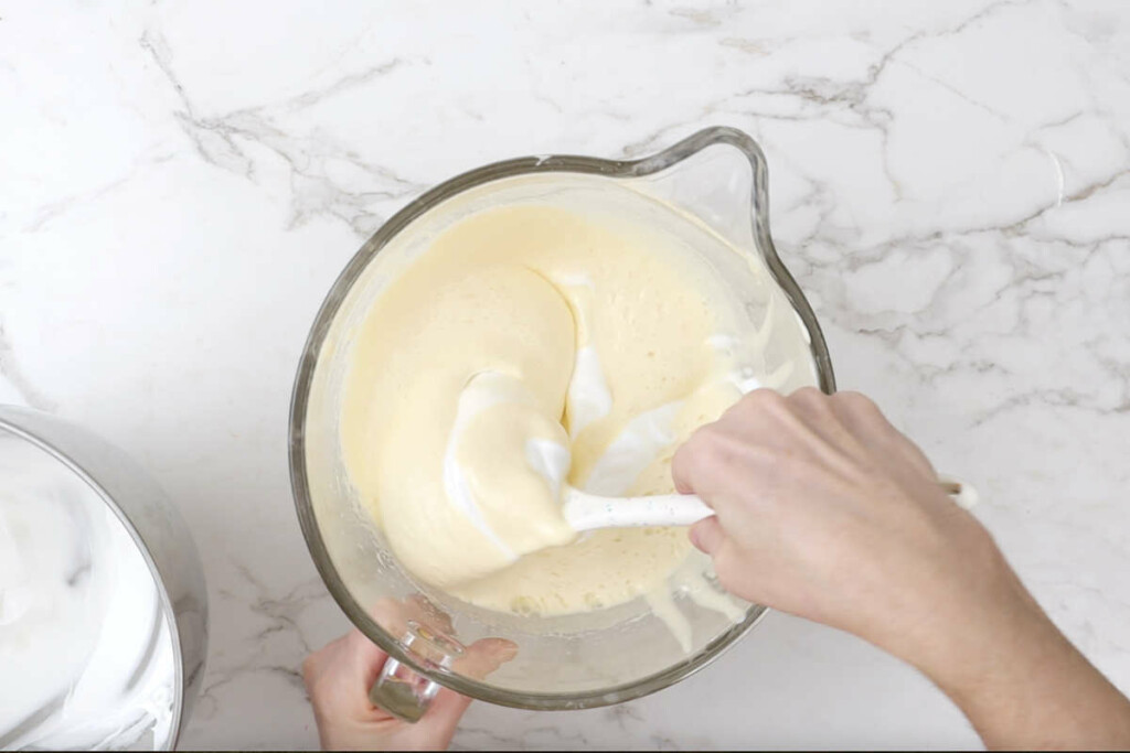 Folding the egg white meringue into the sponge cake mixture.