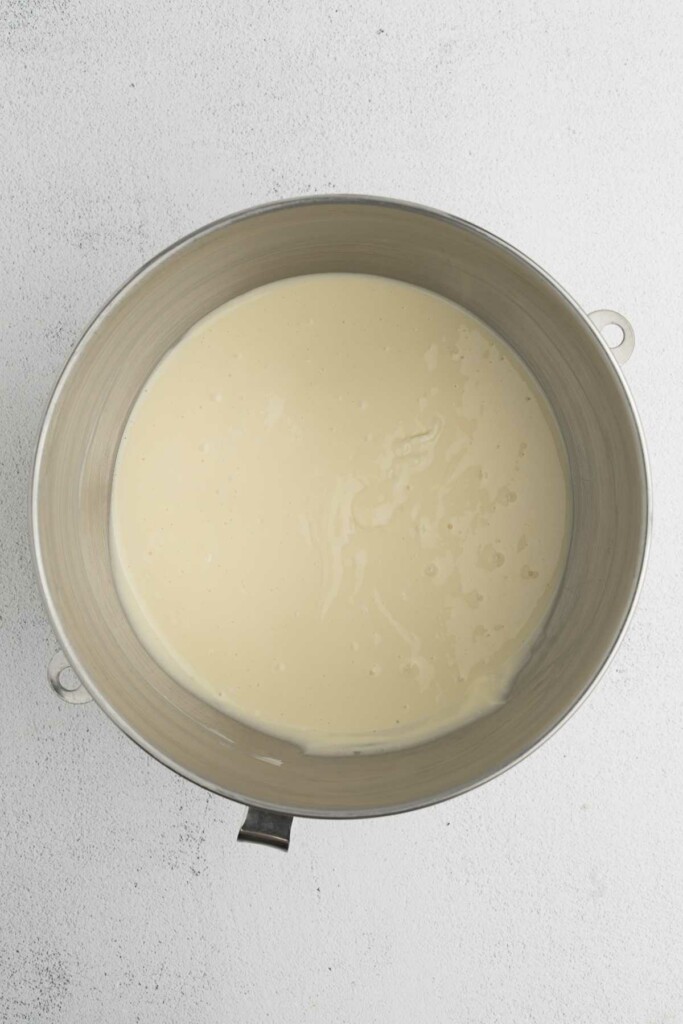 Mixing the cheesecake batter in a mixing bowl.